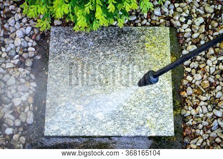 Cleaning With A Pressure Washer Of Granite Garden Slabs, Washing With Water Under High Pressure Of D
