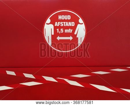 Social Distancing Sign In Public Space. Translation Dutch Text On Sign: \