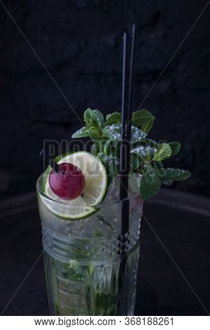 Close-up, Advertising Shot Of A Light Alcoholic Cocktail, With A Sprig Of Mint, Icing Sugar, With De