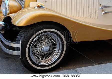 Wheel And A Fragment Of The Front End Of A Vintage Car.