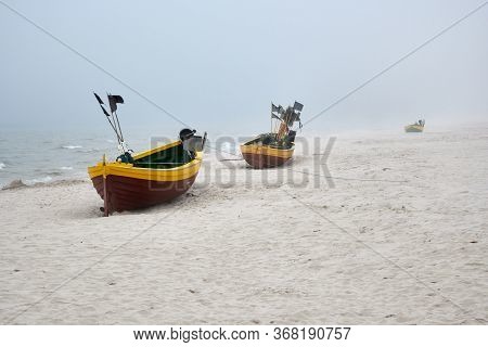 Fishing Boats On The Beach On A Cloudy And Foggy Day. Baltic Sea, Poland