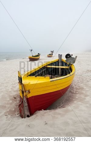Fishing Boats On The Beach On A Cloudy And Foggy Day. Baltic Sea, Poland