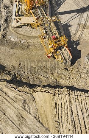 Huge Bucket Wheel Excavator Or Mobile Strip Mining Machine Mining Coal In A Quarry. Heavy Industry C