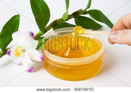 Small Plastic Jar With Sweet Sticky Hair Removal Wax Or Transparent Yellow Sugaring Paste With Woman