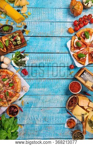 Top view of traditional italian fod on vintage wooden background. Food concept for menu.