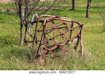 Old Vintage Retro Rusted Abandoned Agricultural Farming Equipment Used To Work With Tractors On Soil