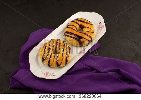 A Top View Donuts Yummy Inside White Plate On The Dark Background