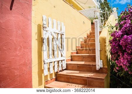 Bright Colorful Courtyard Somewhere In A Small Spanish Town. Concept Travel And Tourism.
