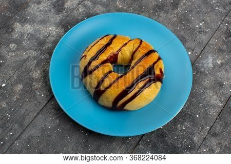 A Top View Donut Sweet Delicious Yummy With Chocolate Inside Blue Palte On The Grey Floor