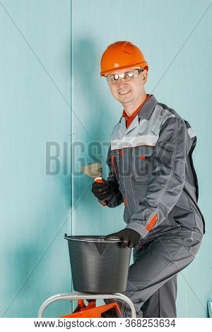 Repair Advertising Concept. Builder, Plasterer, Repairman, Foreman In A Helmet. A Person With A Smil