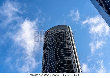 Madrid, Spain - May 10, 2020: Low Angle View Of Office Building In The City Of Madrid Against Blue S