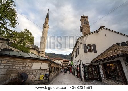 Sarajevo, Bosnia - April 17, 2017: Minaret Of The Gazi Husrev Begova Mosque Next To The Clocktower O