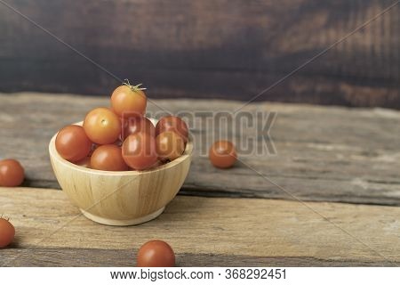 Group Tomato In A Wood Bowl Place On The Wooden Table. Cherry Tomatoes Is A Small That Has A Sweet, 