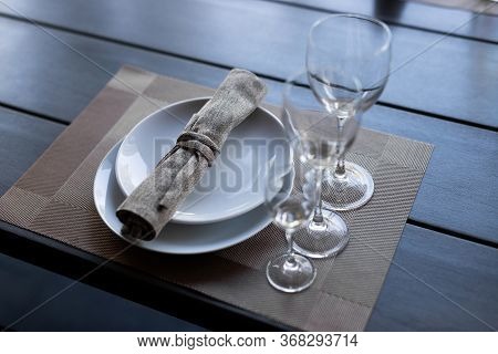 Served Wooden Table With Three Empty Wineglasses