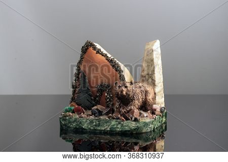 Souvenir Made Of Manlike Stone, Close-up, On A Light Background.
