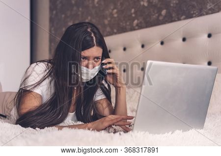 Sick Woman Working On Laptop Lying In Bed, High Fever And Flu, Resting. Work From Home, Covid-19. Di