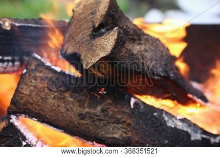 Close-up Of Actively Smoldering Embers Outside. Red Live Coals In Burning Fire. Bonfire On Street. F