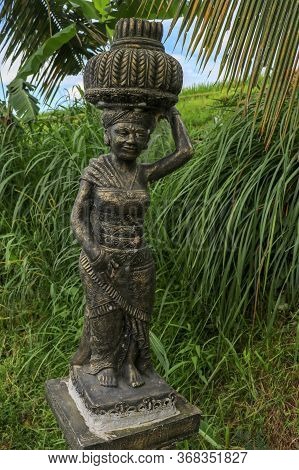 Statue Of A Rice Farmer Near The Rice Field. Balinese Jatiluwih
