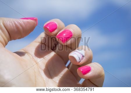 Womans Hand Showing Her Semipermanent Manicure. Pink Colour