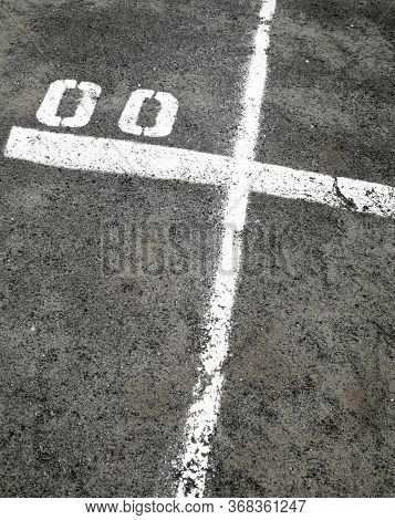 White Marking Lines And Numbers On The Asphalt Surface.
