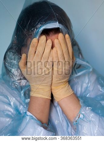 Woman In A Protective Suit Closing Her Face. Distressed Woman. Coronavirus (covid-19) Disease Outbre