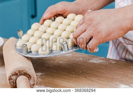 The Cook In The Kitchen Makes Dumplings. The Concept Of Cooking.