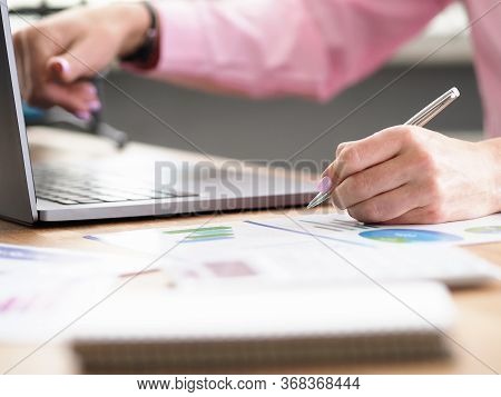 Table At Home Laptop And Documents, Female Hands. Inscription On Documents, Statistical Report. Mode