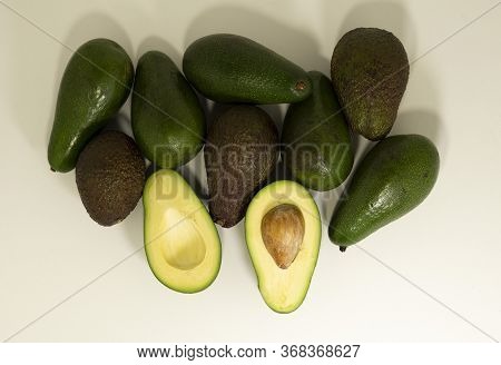 Ripe Avocado Fruits Whole And Sliced On A White Background. Top View.