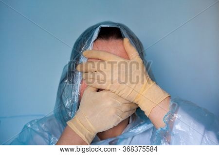 Woman In A Protective Suit Closing Her Face. Distressed Woman. Coronavirus (covid-19) Disease Outbre