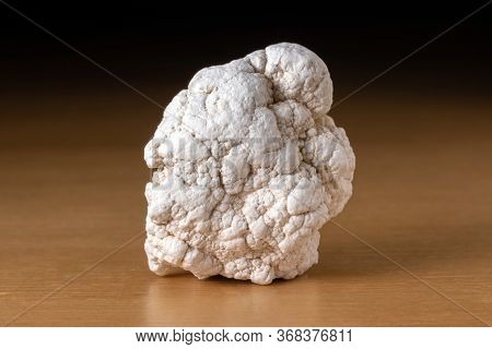 Magnesite Mineral From Namibia Over A Wooden Table