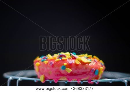 Pink Donuts With Shavings Of Many Colors