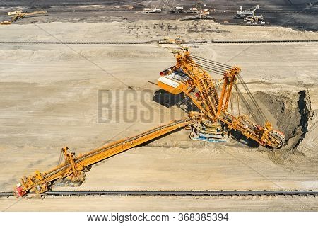 Huge Bucket Wheel Excavator Or Mobile Strip Mining Machine Mining Coal In A Quarry. Heavy Industry C