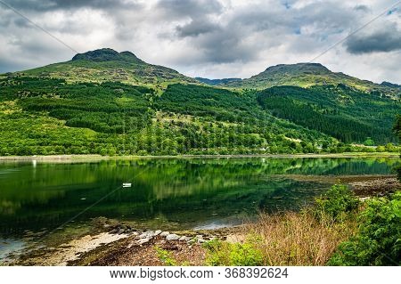 Green Hills Of Arrochar Alps Reflecting In Loch Long. Beautiful Scottish Highlands Summer Scenery On
