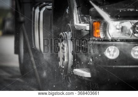 Weekly Truck Maintenance. Detailed Cleaning Semi Truck Using Pressure Washer. Close Up Photo. Transp