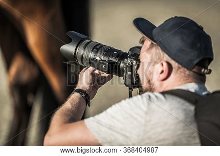 Caucasian Lifestyle Photographer And His Field Project. Men In His 30s Taking Pictures Using Digital