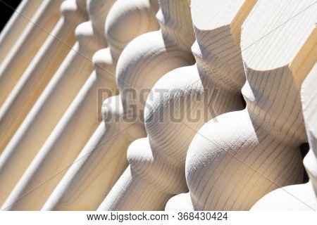 Woodwork. Element Of A Wooden Interior Staircase. Wooden Baluster Close-up View. Handmade Baluster F
