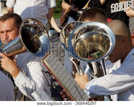 Moscov, Russia - Aug 12, 2017: Sunlighted Adult Musicians Play On Tubes. Festival Of Military Orches