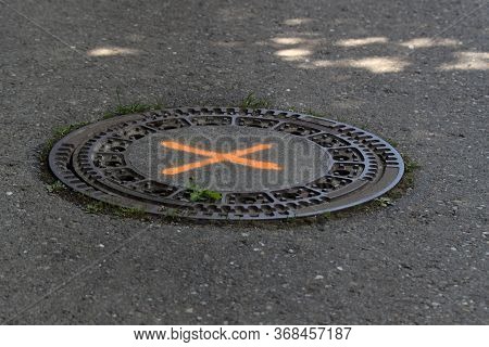 Round Steel Sewer Manhole On The Road