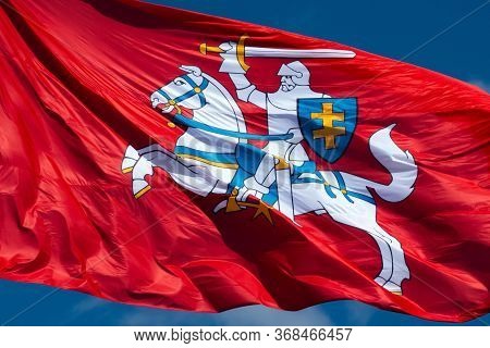 Close Up Of Historic Lithuanian Flag - Vytis Waving In The Wind On A Sunny Day. National Flag Of Lit