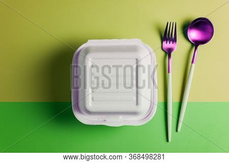 Healthy Food Concept: White Burguer Packaging Closed With Retro Fork And Spoon