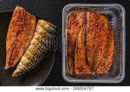 Smoked Marinated Mackerel Fillet Or Fillet Herring Fish With Spices Packed In Box On Plate Over Slat