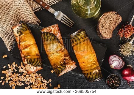 Appetizing Smoked Mackerel Fish Rolls With Spices, Pepper And Bread On Dark Slate Background. Medite