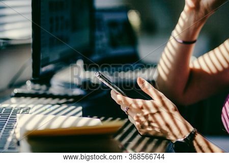 woman hands using smartphone, home office background, social media  influencer