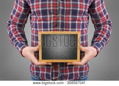 A Man Without A Head With A Black Board In His Hands On A Gray Background
