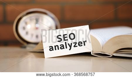 Seo Analyzer - Business Concept Text With A Clock And An Open Book