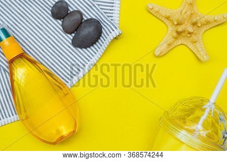 Tanning Oil On A Yellow Background. Smooth Tan. Perfect Body. The Beauty . Sun Protection. Beach Res