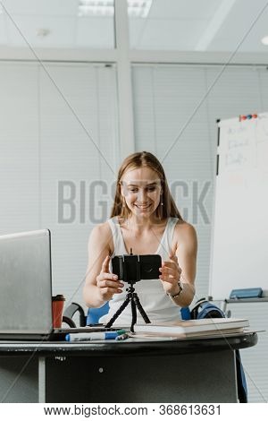 Young Professional Businesswoman Vlogger Coach Talking To Camera. Female Blogger Recording Video. Fi