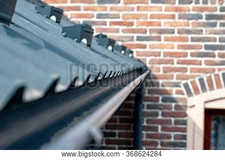 . Gutter System For A Metal Roof. Holder Gutter Drainage System On The Roof.