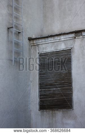 Staircase And Grating On A Concrete Wall