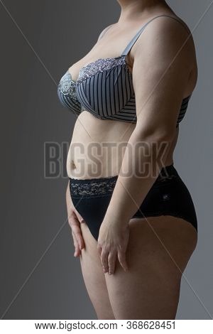 Woman Real Body Plus size Model in lingerie posign, imperfect nonideal
